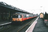 A 6-car 303 arrives at Milngavie on 30 March 1998.<br><br>[David Panton 30/03/1998]