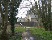 View back along the eastbound platform at Helmsley (Closed 1953) on 1 April 2008, looking west towards the ECML. The station building, now a substantial private house, stands on the other side of the fence, with the old signal box beyond.<br><br>[John Furnevel 01/04/2008]