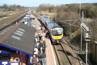 The First TransPennine 0959 Middlesbrough - Manchester Airport service arrives at Thirsk on Tuesday morning in April 2008 with a fair number of passengers waiting on the platform.<br><br>[John Furnevel 01/04/2008]