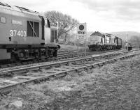 37 403 <I>Isle of Mull</I> with southbound bauxite empties meets 37 407 on a freight for Fort William at Rannoch in the 1980s.<br><br>[Bill Roberton //]