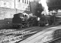 Autumn sunshine at Glasgow Queen Street on a September morning in 1962 finds standard class 4 80090 standing alongside Eastfield B1 61243 <I>Sir Harold Mitchell</I>, about to leave with an express.<br><br>[Colin Miller /09/1962]