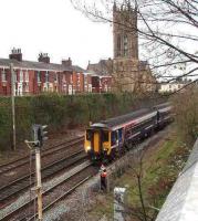 156423 on a service from Blackpool North held at signal PN156, protecting the junction with the WCML. This cutting once contained four running lines but now has two, plus a loop that rejoins the main line by St. Mark's church (now residential apartments). As part of the 2018 electrification of the Blackpool line this signal was replaced by one located at the western end of the cutting.<br><br>[Mark Bartlett 25/04/2008]