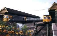 Weymouth station in August 1983, showing a class 33 with a 4TC set for Waterloo standing alongside a DMU with a service for Bristol at platform 4. <br><br>[Ian Dinmore 15/08/1983]