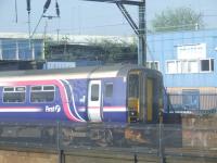 156499 awaits signals as it heads to Glasgow Central on 8th May with the CGUR St Enoch approach line railway bridge in the background <br><br>[Graham Morgan 08/05/2008]