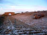 Lit by a brilliant sunset are these amazingly well preserved sleeper indentations about a mile to the east of West Linton and its <i>Broomlee</i> station. The remains of a lineside hut are to the right. The view looks to Macbie Hill.<br><br>[Ewan Crawford 02/01/2002]