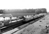 Swindon class 120 and BRCW Class 104 DMUs pass Salwick on a service from Blackpool North in 1982. Not the best quality photograph but it does show the now demolished station canopy to good effect. [See image 26633] <br><br>[Mark Bartlett 14/08/1982]