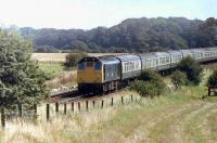 The now preserved Brechin Railway Class 25 25072 heads for Blackpool North between Salwick and Kirkham on a sweltering Bank Holiday Saturday in 1982. At that time Blackpool bound loco hauled (25, 31, 37, 40, 46, 47) trains were still common on Summer Saturdays but alas no more. [see image 12351] <br><br>[Mark Bartlett 28/08/1982]