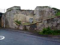 Remains at Kingskettle on 10 June 2007. Stairs to the down platform were inside the curved wall, while outside was the road to the goods yard. I am unaware of what lay behind the door? Kingskettle station lasted for 120 years, with final closure coming in September 1967.<br><br>[David Panton 10/06/2007]