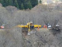 Having collected a load of rocks from the stockpile at the south end of Slochd Viaduct on 28 April, a ro-rail vehicle starts the job of filling in the hole left by the landslip.<br><br>[John Gray 28/04/2012]