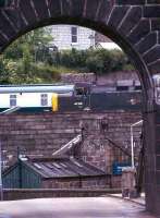Viewed through the western arch of the Wellington suspension bridge, 40106 (in green) moves slowly past on its way to Ferryhill shed, Aberdeen in 1975.<br><br>[John McIntyre //1975]