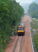 With its lights reflected in the wet ballast, the 1118 Glasgow Queen Street - Alloa service has just passed Cambus loop and is approaching Alloa West through a sudden downpour on 30 May as it nears the end of its 55 minute journey. <br><br>[John Furnevel 30/05/2008]