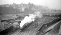 View over the east end of Waverley in the early 60s with an ECML train leaving for the south. To the left of the train, the East box, New Street bus depot and the various railway buildings and sidings have all gone with the new Edinburgh Council headquarters now occupying much of the area. <br><br>[Robin Barbour Collection (Courtesy Bruce McCartney) //]