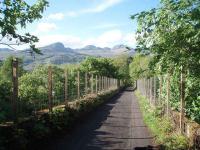 The trackbed over the Dochart viaduct viewed towards Killin station. Deer fencing has been fitted on both sides as the walls are very low. The line can be walked from here through the station and on to Loch Tay. Map Ref NN574327  <br><br>[Mark Bartlett 29/05/2008]