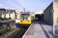 A class 142 stands at Glossop in July 1989 prior to commencing a journey to Manchester Piccadilly.<br><br>[Ian Dinmore /07/1989]