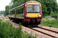 The 1441 Alloa to Glasgow train has passed Cambus Loop in the left<br>
background and is heading for the level crossing.<br><br>[Brian Forbes 02/06/2008]