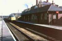 This view towards Rose Grove and Burnley shows the original (local?) red brick buildings at Huncoat as D204 approaches on Cartic empties having travelled over the Copy Pit line. [See image 19323] <br><br>[Mark Bartlett //1972]