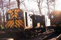 Some record books show Class 11 No. 12122 as being cut up at Crigglestone near Wakefield in 1975 but here it is in 1983, albeit out of use, sitting behind 08016 and 03037 in the loco sidings at the British Oak Disposal Point.<br><br>[Mark Bartlett 24/03/1983]