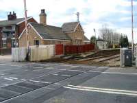 View over the level crossing at Bamber Bridge on 10 March 2008, looking towards the West Coast Main Line and the route to Preston via Farington Curve Junction. The former main station building seen here was refurbished earlier this year and is now used by a local community group.<br><br>[John McIntyre 10/03/2008]