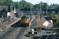 Saturday afternoon shoppers disembark from a Glasgow Queen Street - Perth working on a very warm June 14th 1986. This was one of the last passenger workings on the line one could expect to be Class 27 hauled. While waiting at Queen Street to leave on one of these services, a young rail enthusiast came into my compartment and declared that I'd better prepare for a long journey. He reckoned that there were too many coaches for the Class 27 at the head of the train to lift up Cowlairs incline. Incredibly, he was right - the train stalled mid-incline, services out of Queen Street were disrupted, a class 37 had to be sent to the rescue and I got home an hour late. Respect!<br><br>[Mark Dufton 14/06/1986]