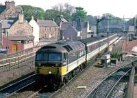 Scene at Dunblane in March 1988, with a Glasgow Queen Street - Aberdeen push-pull set thundering non-stop through the station. The signal gantry will not survive much longer and 158 units will take over the service two years later.<br><br>[Mark Dufton 22/03/1988]