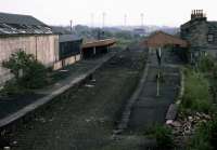 This is an eastward view of Dunfermline (Upper) station in April 1988, shortly before the remains were demolished and a retail park built over the site. The associated railway offices appeared to have been thoughtlessly abandoned, leaving decades of potentially interesting records, plans and reports to be scattered and burned by vandals.<br><br>[Mark Dufton /04/1988]