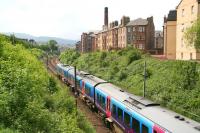 Heading southwest from Haymarket towards Carstairs on 6 June 2008 is the 1152 First TransPennine service to Manchester Airport. The train is running alongside the rear of the tenements on the south side of Slateford Road and will shortly reach the site of the original Slateford Junction where the line becomes the former Caledonian route to Carstairs. The Pentland Hills form the horizon.<br><br>[John Furnevel 06/06/2008]