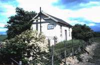 The old station building at Saltoun on the Gifford branch June 1985. Closed to passengers as early as 1933, the line continued in use to here for freight until 1965. The station building looks as though it had been put to alternative use since closure, as indicated by the sign on the side which reads...<I>Agricultural Premises - Used by Brucellosis Accredited Cattle - No Dogs or Horses Please - Disinfect Feet.</I> [Brucellosis was erradicated amongst UK herds in 1979 - although it has since been reintroduced on several occasions by imported cattle!] <br><br>[David Panton 07/06/1985]