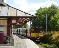 314 209 for Neilston pulls into Cathcart on 14 June 2008 alongside one of the experimental small childrens waiting rooms...<br><br>[David Panton 14/06/2008]