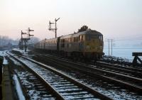 The sun and thermometer mercury are both about to drop out of sight at Manningtree in January 1979.  Leaving for Ipswich and Norwich is a Class 31 on an express passenger working from Liverpool Street, a challenging task normally given to a Class 47. The semaphores also controlled the junction with the Harwich branch, and were replaced when the junction was remodelled in 1980.<br><br>[Mark Dufton 19/01/1979]