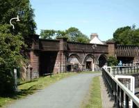 The course of the Caledonian line to Dumbarton sweeps past the western end of the Forth & Clyde Canal at Bowling on 14 June.<br><br>[David Panton 14/06/2008]