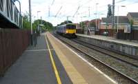 Northbound arrival at Euxton Balshaw Lane station on 14 June 2008 as  150142 draws to a halt with a Northern Trains service from Liverpool to Blackpool North. The station is located on the slow lines with the fast lines off picture to the left.<br><br>[John McIntyre 14/06/2008]