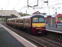 View east at Shettleston as 320 315 arrives on a Balloch service on 15 September 2007. The junction beyond the train, once the old NB route to Hamilton, now leads into the large PW depot operated by STC, some of which can be seen in the right background on the other side of Hallhill Road.<br><br>[David Panton 15/09/2007]