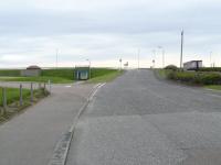 A June 2008 recapture of a photograph taken 28 years previously [see image 17852] showing the view from Kessock Road of what replaced the railway bridge. The road now joins the harbour access road, formerly the railway line, running across the centre of the photograph. An underpass allows for pedestrian access to the beach.<br><br>[John Williamson 08/06/2008]