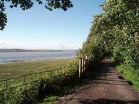 The Glasson Dock branch followed the Lune estuary for most of its length and is particularly close to the river around Ashton Hall, north of Conder Green. View along the trackbed/cycleway towards Aldcliffe and Lancaster with the Lake District mountains in the distance. Map Ref SD 456577.   <br><br>[Mark Bartlett 23/06/2008]