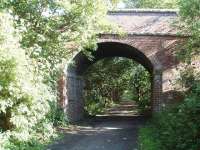 Ashton Hall, on the Glasson Dock Branch (closed passengers 1930 and goods 1964), was the site of a private halt. This bridge carries a private drive over the trackbed/cycleway and still has two brackets in the brickwork that presumably carried telegraph wires.  View south towards the intermediate station of Conder Green. Map ref SD 456570. (On visiting this location again in August 2009 the arch walls had sadly been <I>graffitied</I>).<br><br>[Mark Bartlett 23/06/2008]