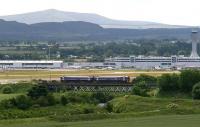 A new interchange station is to be built at Gogar in order that train passengers can change onto a tram to reach Edinburgh Airport. The photograph shows the 1241 ex-Waverley Fife Circle service running alongside the airport and crossing the River Almond on 26 June 2008 near the site of the former Turnhouse station (closed 1930).   <br><br>[John Furnevel 26/06/2008]