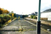 The derelict Dunfermline Upper station in 1988 looking in the direction of Alloa. The high concrete retaining wall to the left of the bridge in the centre of the picture still stands, although a B&Q car park now occupies the ground in front.<br><br>[Grant Robertson //1988]