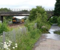 View towards Dalmeny station from Dalmeny North Junction on 26 June with trains to and from the Forth Bridge passing on the main line. The northbound train has just run past the crossover for the line to Winchburgh Junction, which joins the formation just in front of the 40mph speed restriction sign. Dalmeny Junction signal box stood on the other side of the fence on the left betweeen the main line and the South Queensferry branch, the trackbed of which can be seen running under the old arched bridge on the right from its junction with the main line behind the camera.<br><br>[John Furnevel 26/06/2008]