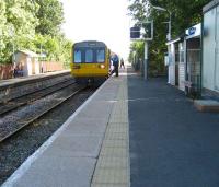 Looking south towards Ormskirk at Rufford station as the signalman collects the staff for the section from Ormskirk and hands over the token for the section to Midge Hall on 25 June 2008. Rufford is the only passing loop on the line between Farington Curve Junction and Ormskirk.<br>
<br><br>[John McIntyre 25/06/2008]