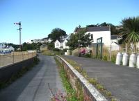 The former Instow station on the Torrington branch on 3 July 2008. The platform is fully fitted out with lamps, station signs, seats and milk churns. The level crossing is protected by signals and the signalbox retains all of its equipment. There is even some track in place across the road and for about 50 yards on either side. It will be a long wait for the next train however, as the trackbed is now part of the <I>Tarka Trail</I> long distance cycle path.<br>
<br><br>[John McIntyre 03/07/2008]