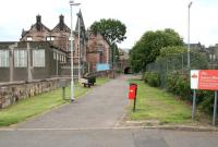 The southern end of the path running through Alloa along the route of the old Wagonway seen in July 2008 looking north from the Castle Street industrial area towards Bedford Place. Note the <I>Waggon Way</I> sign attached to the wall on the left and the information point beyond. From here the route south towards the Forth becomes difficult to trace with clearance and redevelopment having taken place (including goods depots of both the NB and Caledonian that once occupied land off to the left). The impressive building in the background (with the unfortunate extension) facing onto Bedford Place is the 1875 Alloa Burgh School, now occupied by Clackmannanshire Council.<br><br>[John Furnevel 02/07/2008]