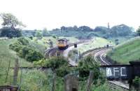 Having just crossed over the WCML (off picture to the left), a Cravens 105 DMU drops down the 1908 built curve to join it at Farington Curve Junction with a Colne - Preston service. Coming in from the right is the line from Liverpool / Ormskirk. The scene is little changed since the photograph was taken in June 1981 apart from the DMU itself and the Liverpool / Ormskirk line, which has since been singled.<br><br>[Mark Bartlett 12/06/1981]