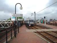 Metrolink tram 2006, on a Manchester Piccadilly - Eccles service, climbs away from the G-Mex/Central tramstop onto the elevated Cheshire Lines formation. The structure on the left is a footbridge, dating from 1985, giving direct access to the Deansgate station platform. <br><br>[Mark Bartlett 07/07/2008]