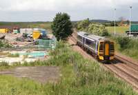 A 158 heads north towards the Forth Bridge on 26 June past a compound associated with the nearby tramworks. This site has been proposed as the location for the Edinburgh Airport tram-train interchange (to be called Edinburgh Gateway).<br><br>[John Furnevel 26/06/2008]