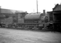 One of the diminutive class Y9 0-4-0ST locomotives No 68101, complete with dumb buffers and wooden tender, stands at Dunfermline shed in 1959 after completing a days work. <br><br>[Robin Barbour Collection (Courtesy Bruce McCartney) 19/05/1959]