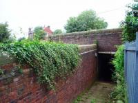 Bay Horse subway entrance on the down side showing the remains of the old platform wall and Station House visible on the opposite side of the line. The down platform access was on the right, just before the subway but now fenced off. <br><br>[Mark Bartlett 14/07/2008]