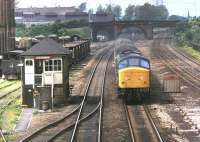 Peak Class 45 No. 45143 approaches Loughborough from the north on a St Pancras express in June 1981. Just above the roof of the signal box is an industrial class 08 shunter working in the aggregate sidings - the now preserved D3101 [Identity confirmed by Vic Smith - Ed]<br><br>[Mark Bartlett 15/06/1981]