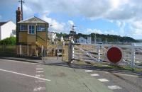 Looking south over the former level crossing at Instow towards the signalbox and station on 3 July 2008. The track may be in place across the road but unfortunately there is not much on either side. The broken white lines running over the crossing mark the <I>Tarka Trail</I> which follows the trackbed from Torrington to Barnstaple.<br>
<br><br>[John McIntyre 03/07/2008]