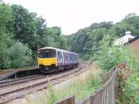 The closed station at Wilpshire sees 150149 heading for Clitheroe passing the down platform. The white building, just visible on the up side, is the former station, closed in 1962 and now a home. [See image 19311] for the same location over thirty years earlier. <br><br>[Mark Bartlett 17/07/2008]