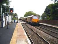 <I>Northern Belle</I> stock with 67028 leading and 67030 at the rear enters Rufford station with the evening ecs movement from Crewe to Ormskirk on 18 July 2008. The train was operating from Euston in connection with the Open Golf Championships at Royal Birkdale near Southport. When the normal service is one single or two car unit, it is quite a difference when you get 11 coaches plus a locomotive at either end trying to use the loop and the platforms. It is reported that only 3 of the 11 coaches were able to access the platform at Ormskirk!<br>
<br><br>[John McIntyre 18/07/2008]